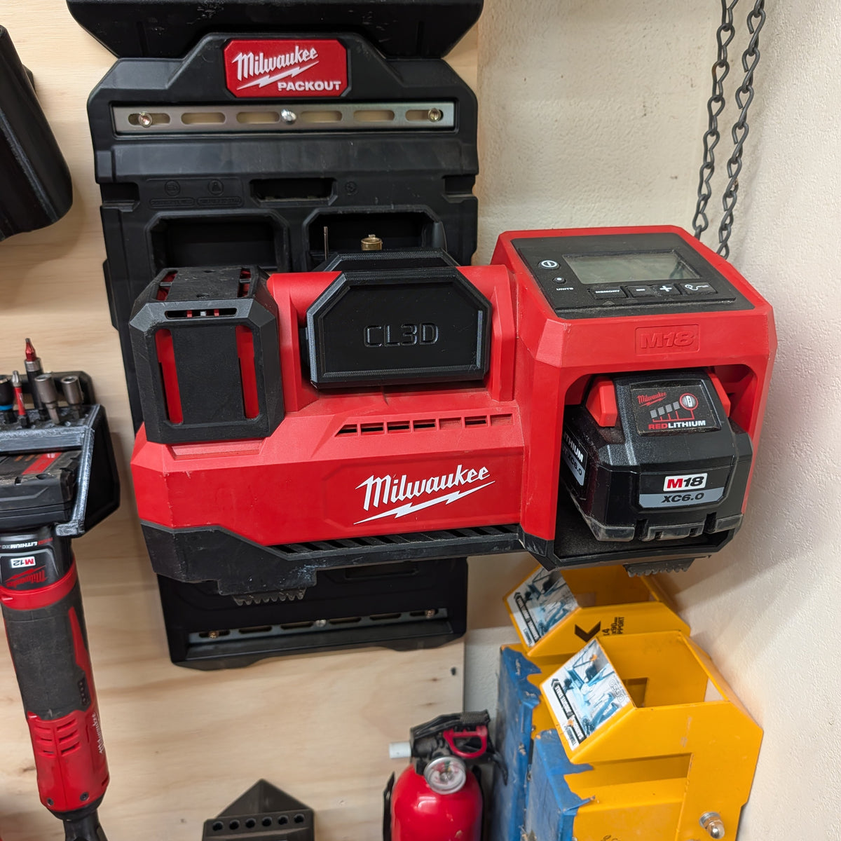 Milwaukee M18 inflator holder mounted on a PACKOUT-compatible wall plate